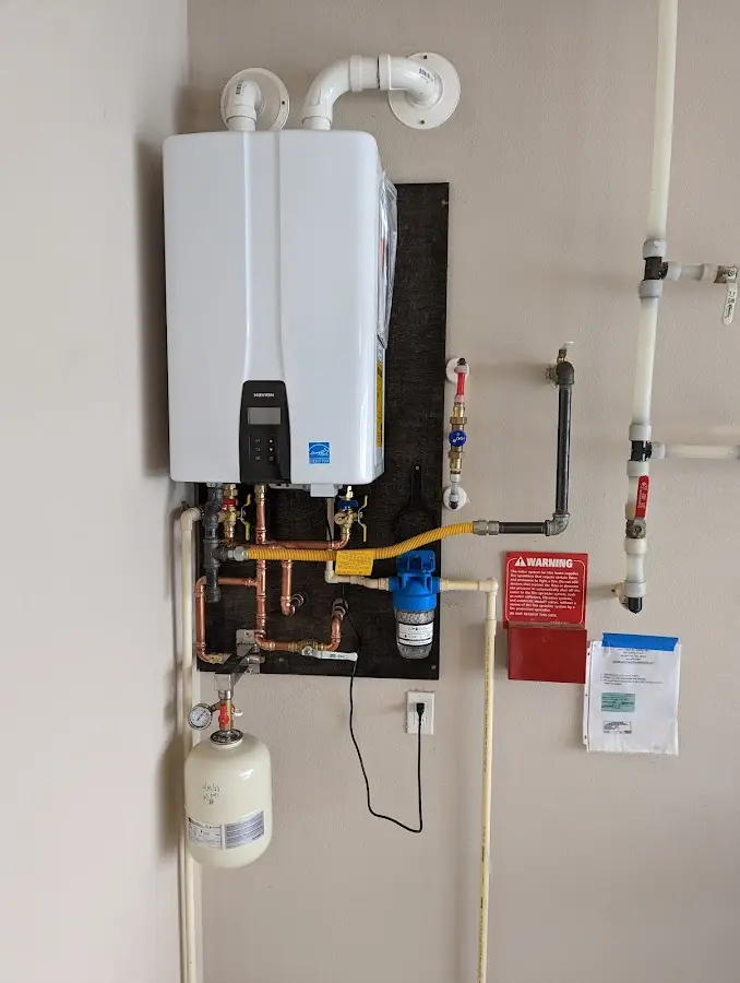 Professional plumber installing copper piping in a Bel Aire home